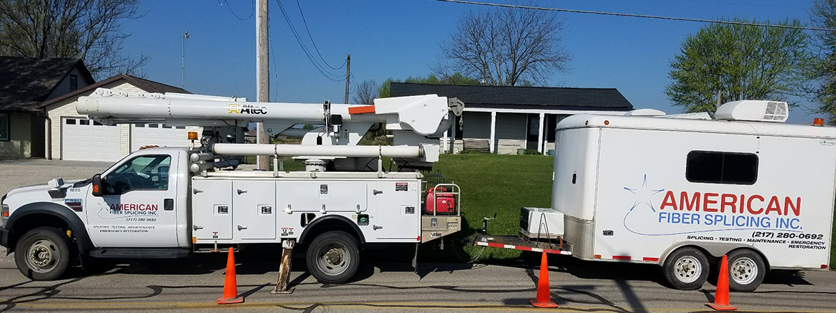 American Fiber Splicing truck and trailer parked along street